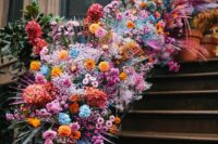 26 bright wedding banister decor with pink, orange, yellow and blue flowers plus pink fronds is jaw-dropping