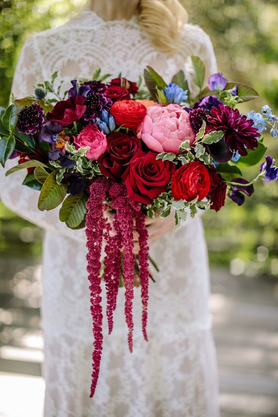a bold wedding bouquet with pink, red, burgundy, purple and blue blooms, foliage and amaranthus is amazing for the fall