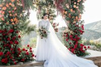 27 a breathtaking wedding arch with greenery, red, peachy, yellow and pink blooms is a fantastic idea for a wedding