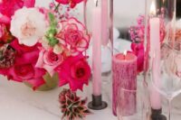 31 a beautiful and bold wedding tablescape with hot pink and white blooms, pink candles of various sizes, white porcelain is amazing
