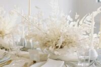 32 a really ethereal dried leaf wedding centerpiece with lunaria is ideal for an all-white wedding tablescape and it looks chic and elegant