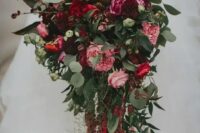 33 a bold exquisite cascading wedding bouquet of pink, burgundy blooms, greenery, dark foliage, artichokes and bulbs going down for a fall wedding