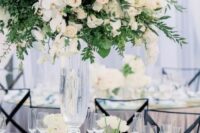 33 a refined garden wedding centerpiece of much greenery, white roses and orchids is a lush and very beautiful solution
