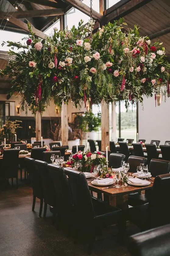 a lush greenery and floral overhead wedding decoration creates a strong wow effect