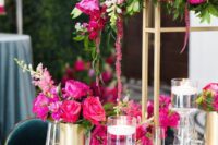 35 a bold wedding centerpiece on tall gold stands, with hot pink and fuchsia blooms and greenery plus matching arrangements on the table