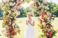 35 a jaw-dropping wedding arch with some foliage, pink, blush, red and neutral blooms all over is amazing for a bright summer wedding