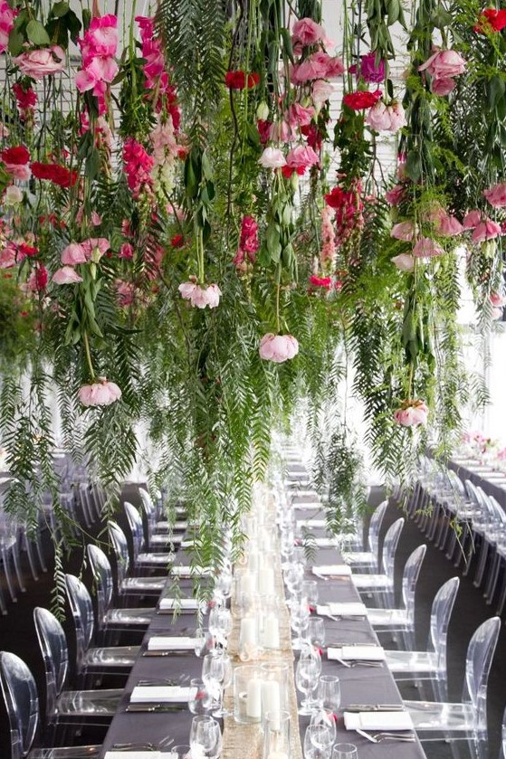 keep your reception clutter-free creating such lush greenery and pink bloom installations over the tables