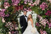 37 a lush and chic wedding arch decorated with greenery, blush, mauve and lilac blooms is an amazing idea for spring and summer