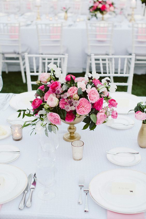 a bright pink and blush wedding centerpiece with foliage and white blooms is a cool idea with a touch of color