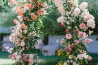 39 a lush and textural wedding arch decorated with greenery, pink, peachy, blush, orange and mustard blooms is a color statement