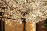 40 an oversized blooming tree wedding centerpiece created with cherry blossom will easily create an outdoor feel in an indoor space