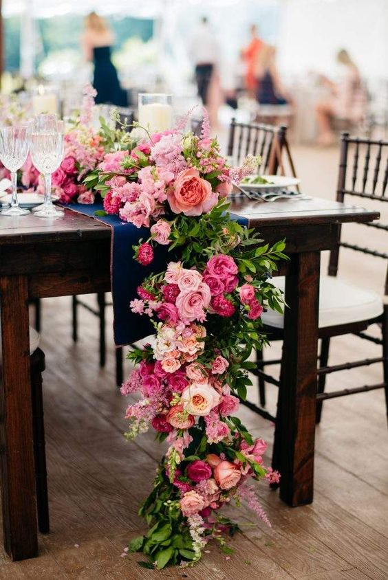 a cool pink wedding table runner with light and hot pink blooms and greenery is a lovely idea for styling your wedding in pink