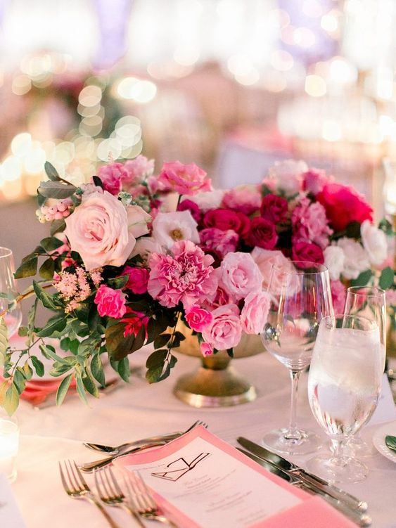 a gorgeous pink wedding centerpiece with blush, hot pink and fuchsia flowers and greenery is a fantastic idea for a bright wedding