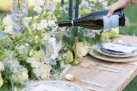 43 classic wedding table decor done with white and blue delphinium, greenery and blue printed plates is amazing