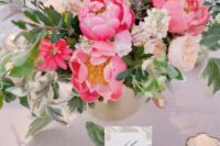 46 a pretty pink wedding centerpiece with peony roses, pink peonies, greenery and blush blooms is a chic idea