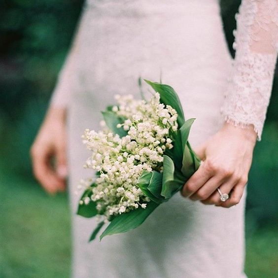 a tiny and lovely lily of the valley wedding bouquet is a classic and cool idea for a bride in spring or summer