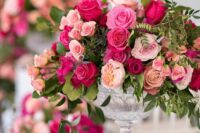 47 a sophisticated wedding centerpiece of light, peachy and bold pink blooms and greenery is a refined idea