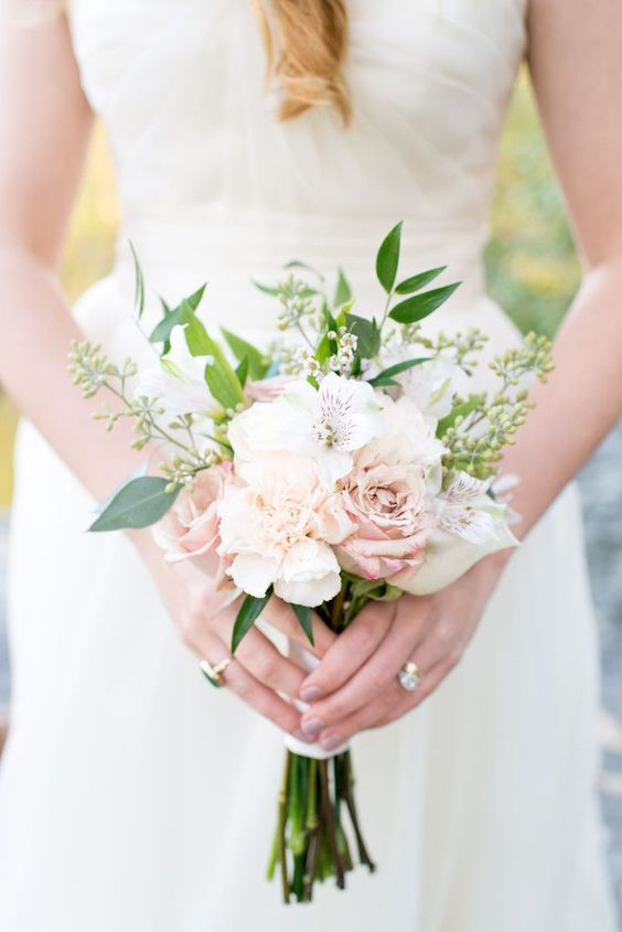 a tiny wedding bouquet with white and blush blooms, greenery and waxflower is great for spring and summer