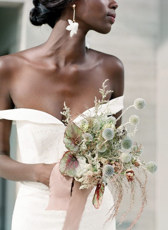 a tiny and pretty wedding bouquet composed of grasses, dried allium and leaves plus blush ribbon is jaw-dropping