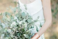 52 a casual greenery wedding bouquet of eucalyptus and some blooming branches looks very chic