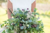 53 a lush summer wedding bouquet with lots of greenery, small pink blooms and feathers is a bold idea