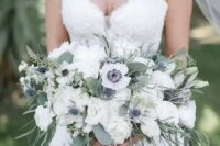 a beautiful and breezy white wedding bouquet of anemones, peonies, thistles and greenery of various kinds