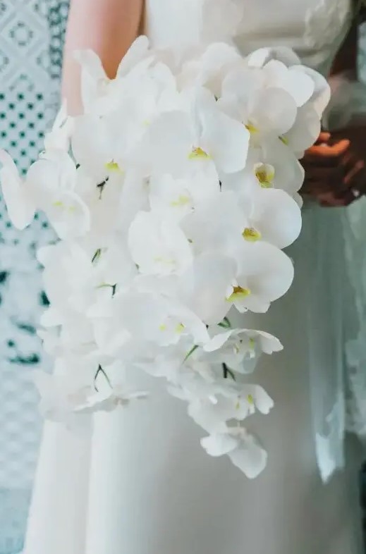 a cascading white orchid wedding bouquet is a refined and timeless idea for an exquisite bride