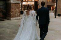 a chic wedding dress paired with a sheer wedding capelet with lace applique on the shoulder are amazing