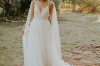 a delicate A-line lace applique wedding dress with spaghetti straps and a sheer bridal cape veil are an amazing combo