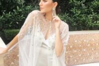 a delicate and beautiful sheer bridal capelet with silver celestial embroidery is a fantastic and lovely accessory to rock