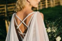 a dove grey wedding dress with a strappy back and a matching sheer cape veil are a perfect combo