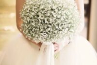 a dreamy wedding bouquet composed of only baby’s breath and white ribbons is a very chic and very romantic idea