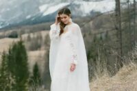 a jaw-dropping refined winter bridal look with an off the shoulder petal wedding dress, a sheer capelet and matching earrings
