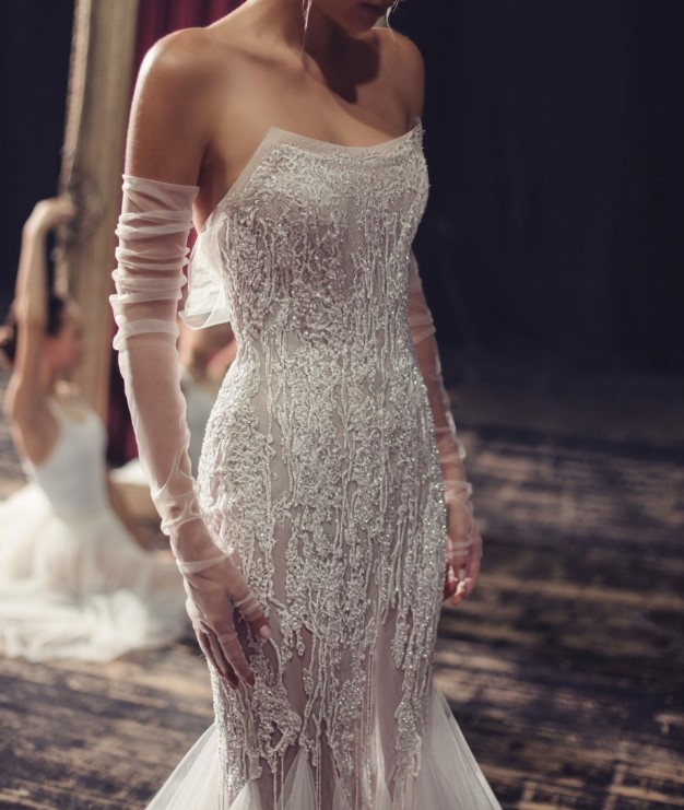 a jaw-dropping strapless beaded lace applique mermaid wedding dress paired with soft fingerless gloves that accent but don't distract attention