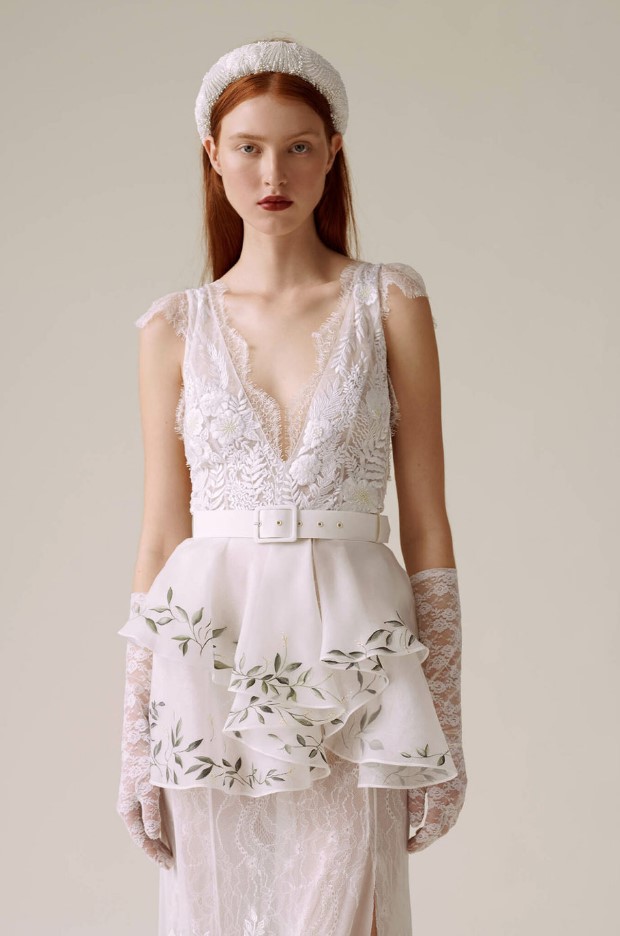 a lace and lace applique wedding dress with a V neckline and cap sleeves, a peplum detail and long lace sleeves