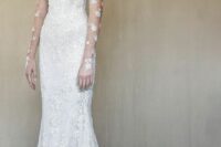 a lace strapless mermaid wedding dress with a train and sheer gloves with lace applique are an adorable combo for a refined bride