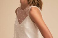 a minimalist plain wedding dress with a sheer sleeveless pearl dress topper are a beautiful and romantic combo