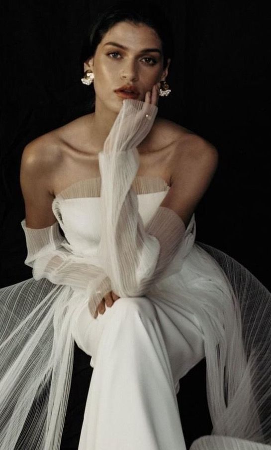 a modern strapless wedding dress with a mesh cover and matching mesh fingerless gloves for a romantic and airy look
