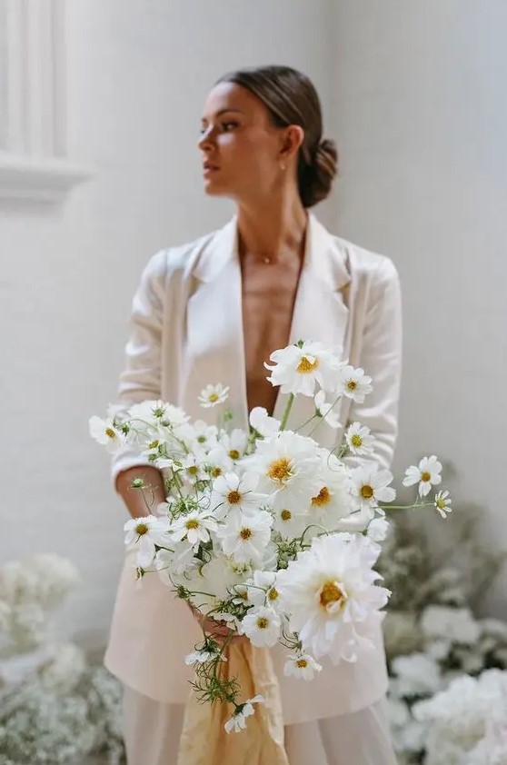 a modern white wedding bouquet with no greenery will match a modern or minimalist bridal look