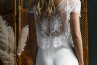 a plain strap wedding dress with a lace dress topper with cap sleeves are a beautiful and delicate ensemble
