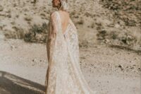 a tan embroidered star wedding dress plus a matching cape veil with a train are gorgeous for a celestial bride