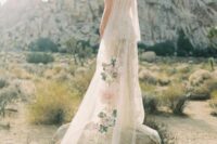 a unique ivory cape veil with oversized floral appliques and a train is a gorgeous statement for your look