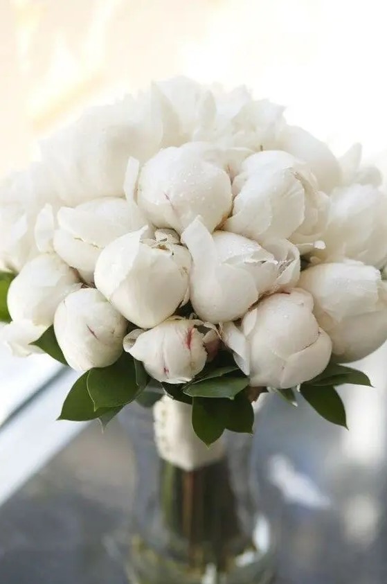 a white peony wedding bouquet is timeless classics that matches any bridal look and brings a touch of romance to it