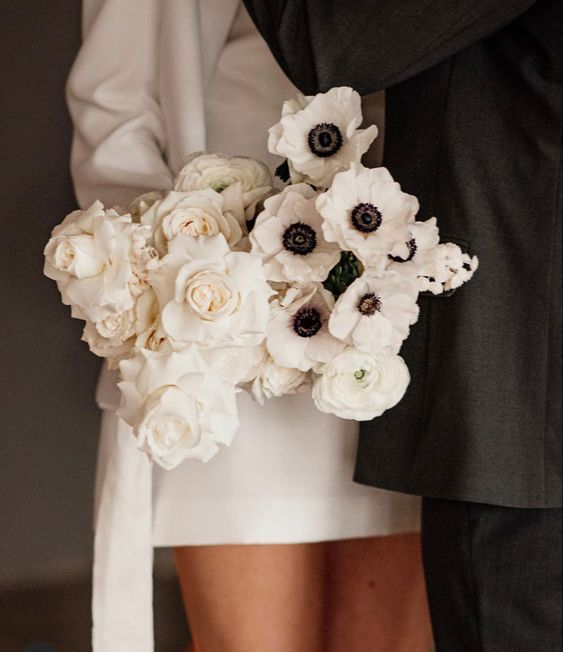 a white rose, ranunculus and anemone wedding bouquet is a great idea for a minimalist or modern bride