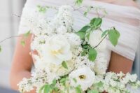 a white wedding bouquet of blooming branches and a couple of peonies will be a nice idea for spring or summer