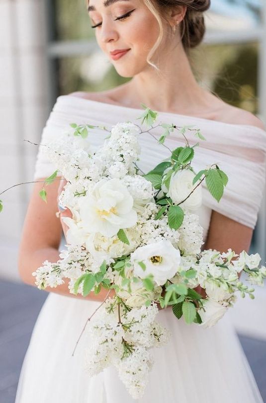 a white wedding bouquet of blooming branches and a couple of peonies will be a nice idea for spring or summer
