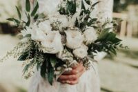 a white wedding bouquet of peony roses, greenery and feathers is a lovely idea for a summer wedding