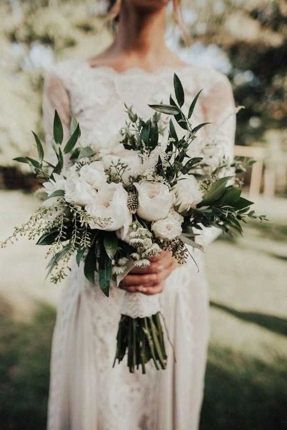 a white wedding bouquet of peony roses, greenery and feathers is a lovely idea for a summer wedding
