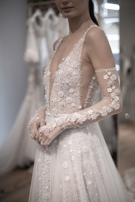 an A-line embellished lace applique wedding dress paired with matching long gloves are a gorgeous and trendy combo for a bride