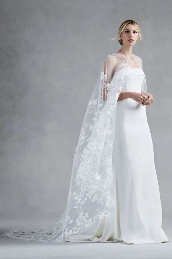 an ethereal lace applique cape makes a minimalist wedding dress look more feminine